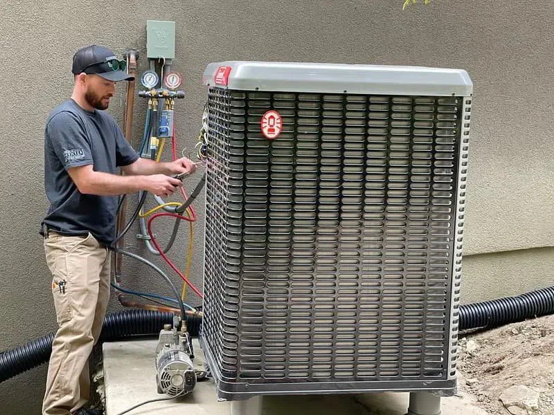 HVAC technician working on a heat pump