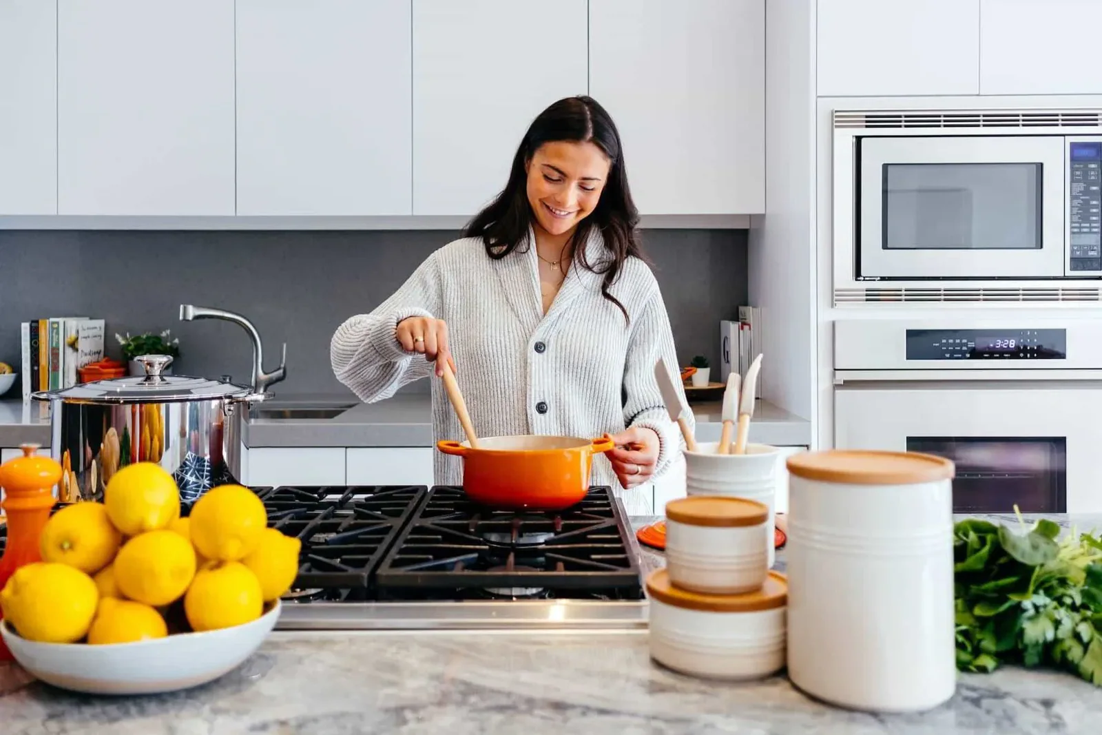 young woman cooking in a well lit modern kitchen