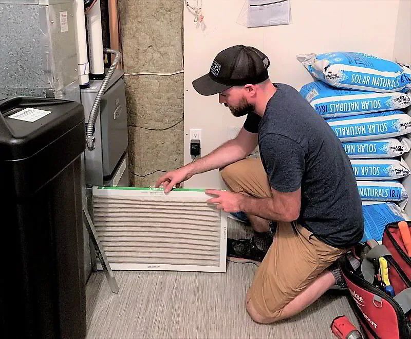 HVAC tech changing air filter