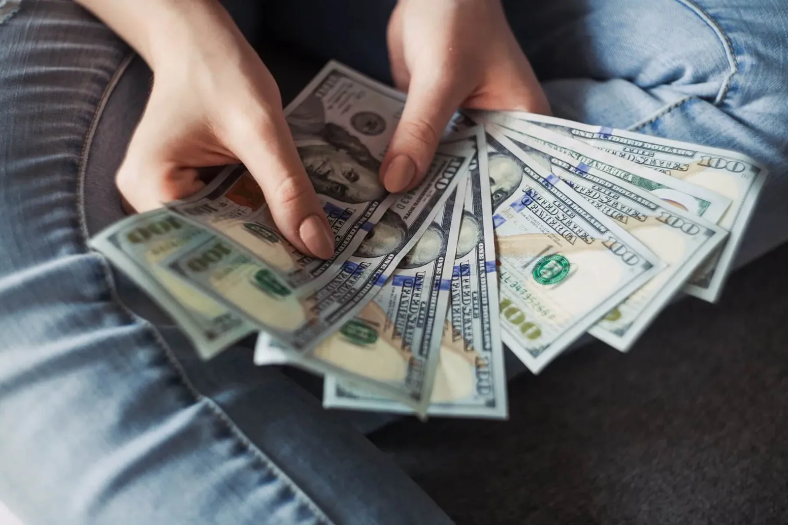 DIY House flipper counting 100 dollar bills