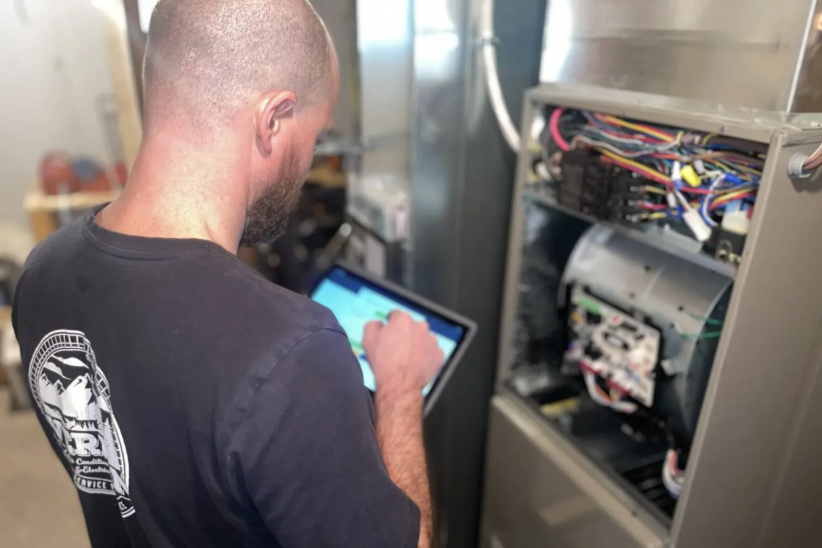 Professional HVAC technician repairing a furnace